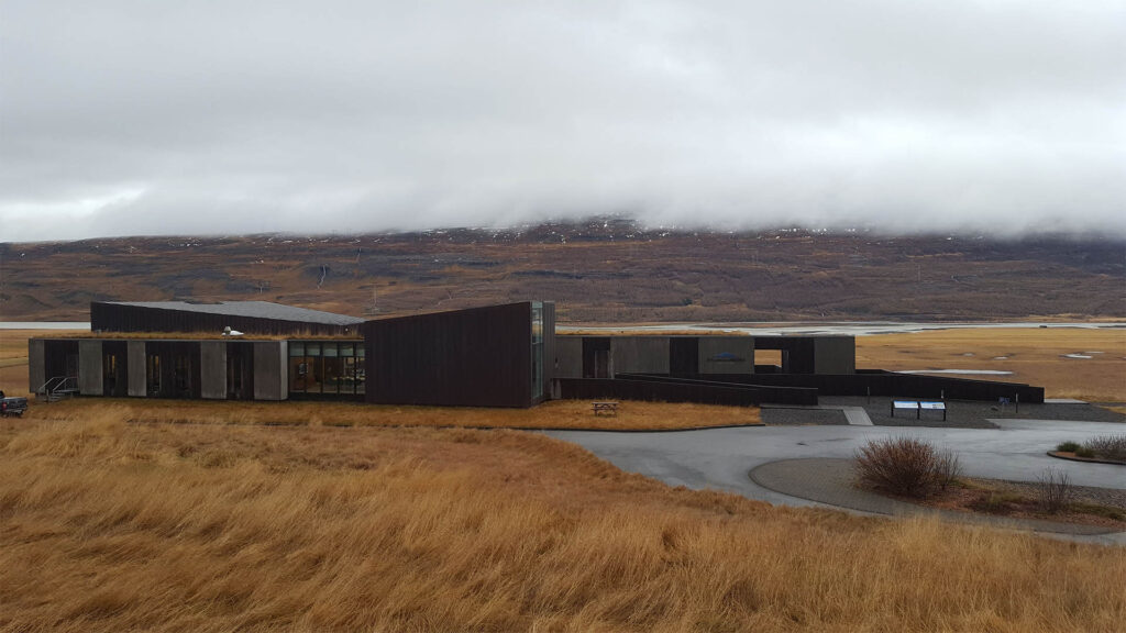 Snæfellsstofa in the winter, no snow, brown grass and low clouds.