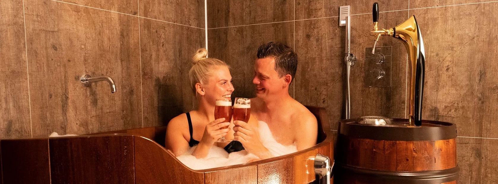Happy couple enjoying a Beer Bath