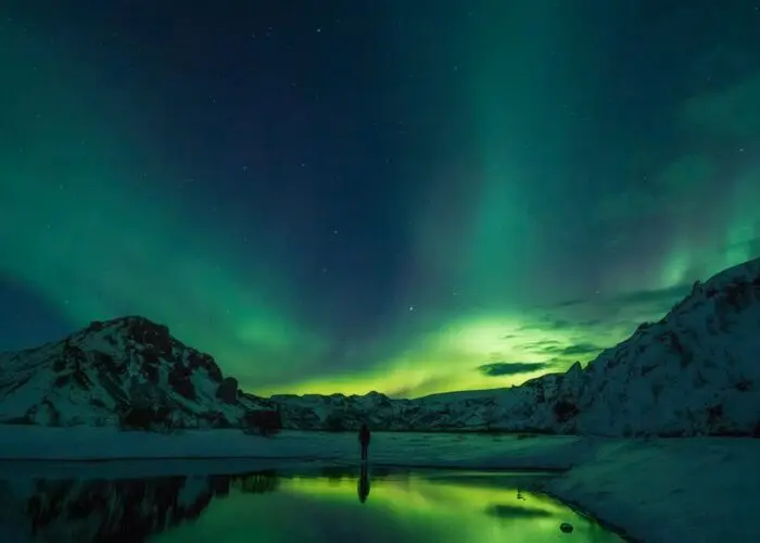 Aurora borealis reflecting on the surface of a calm lake