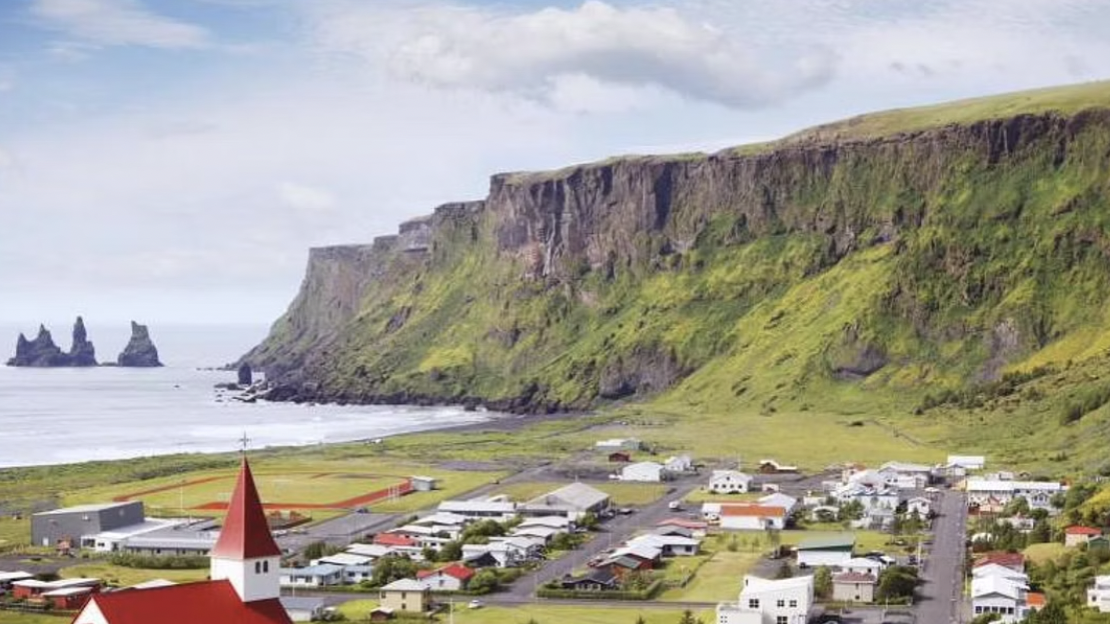 Vik is a small town with a church in Iceland, next to the Black Sand Beach on the South Coast
