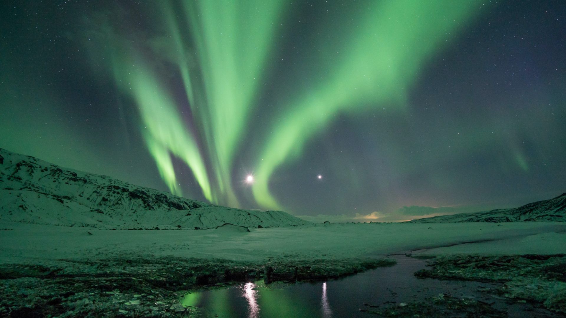 The Northern Lights in Iceland during winter with snow