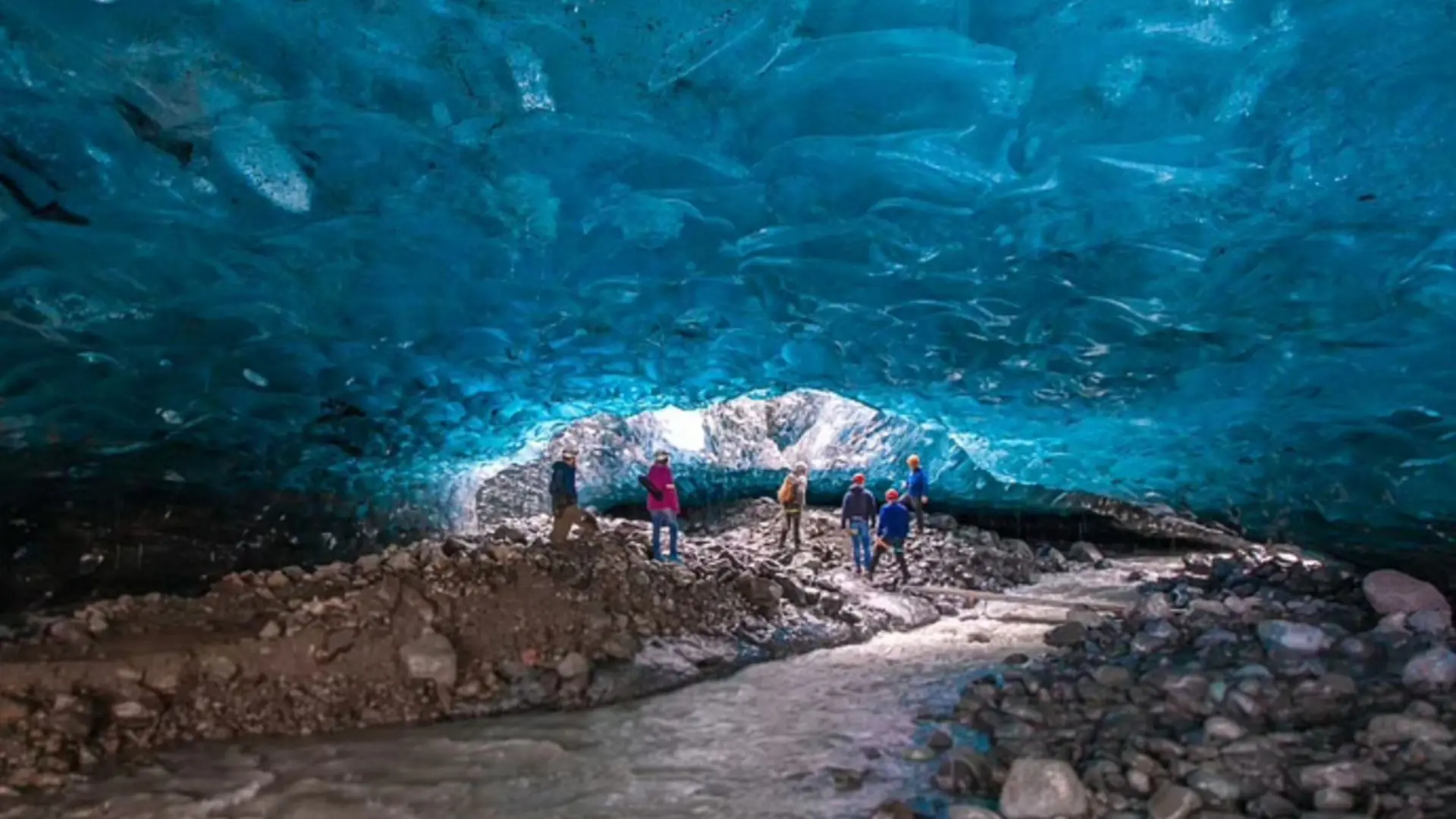 Tourists exploring the ice cave in Iceland