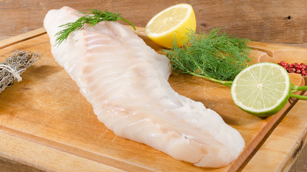 cod fillet ready to be cut to be baked in an oven