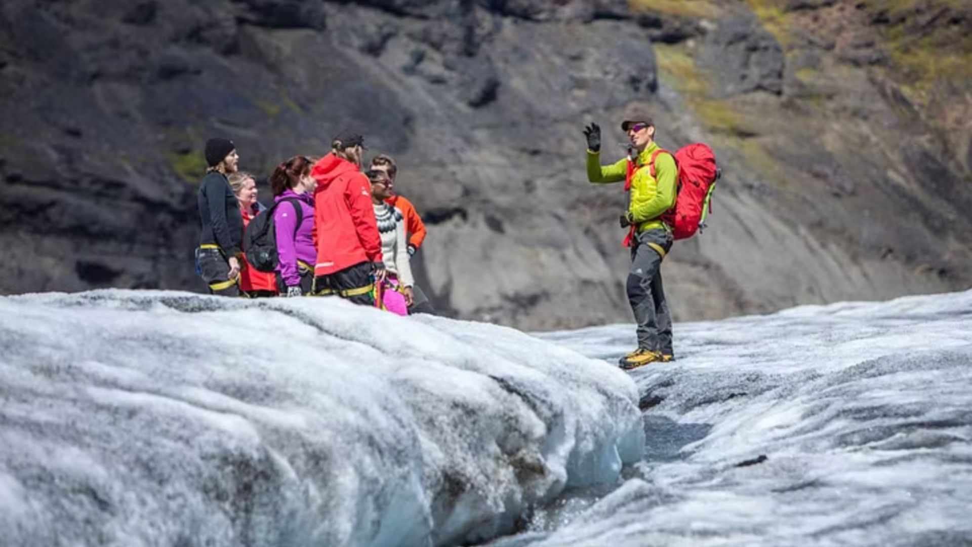 Guide with tourists on the glacier in Iceland