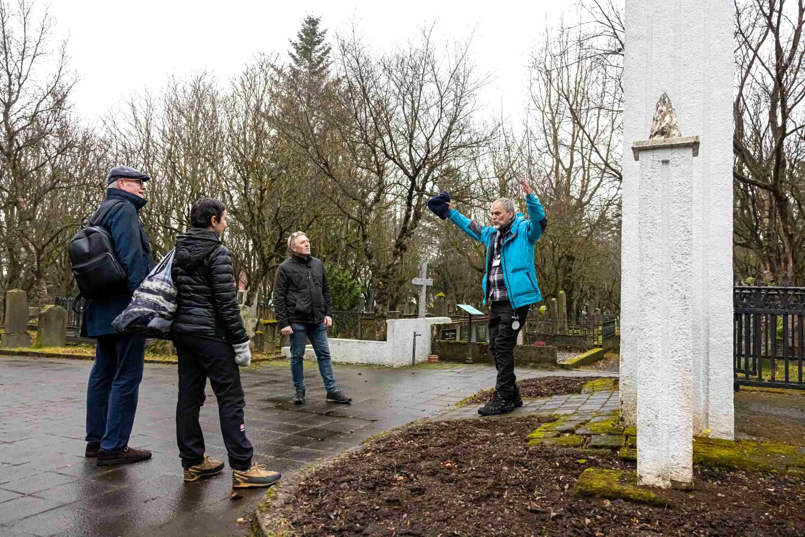 A Guide from Your Friend in Reykjavik telling a story to guests while visiting the oldest Graveyard in Iceland