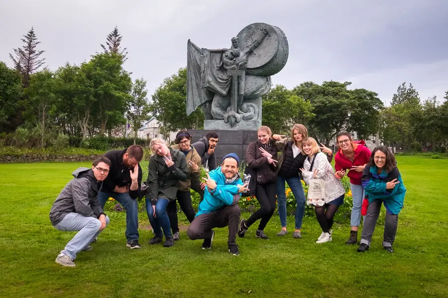 A fun group posing in front of a statue in the park