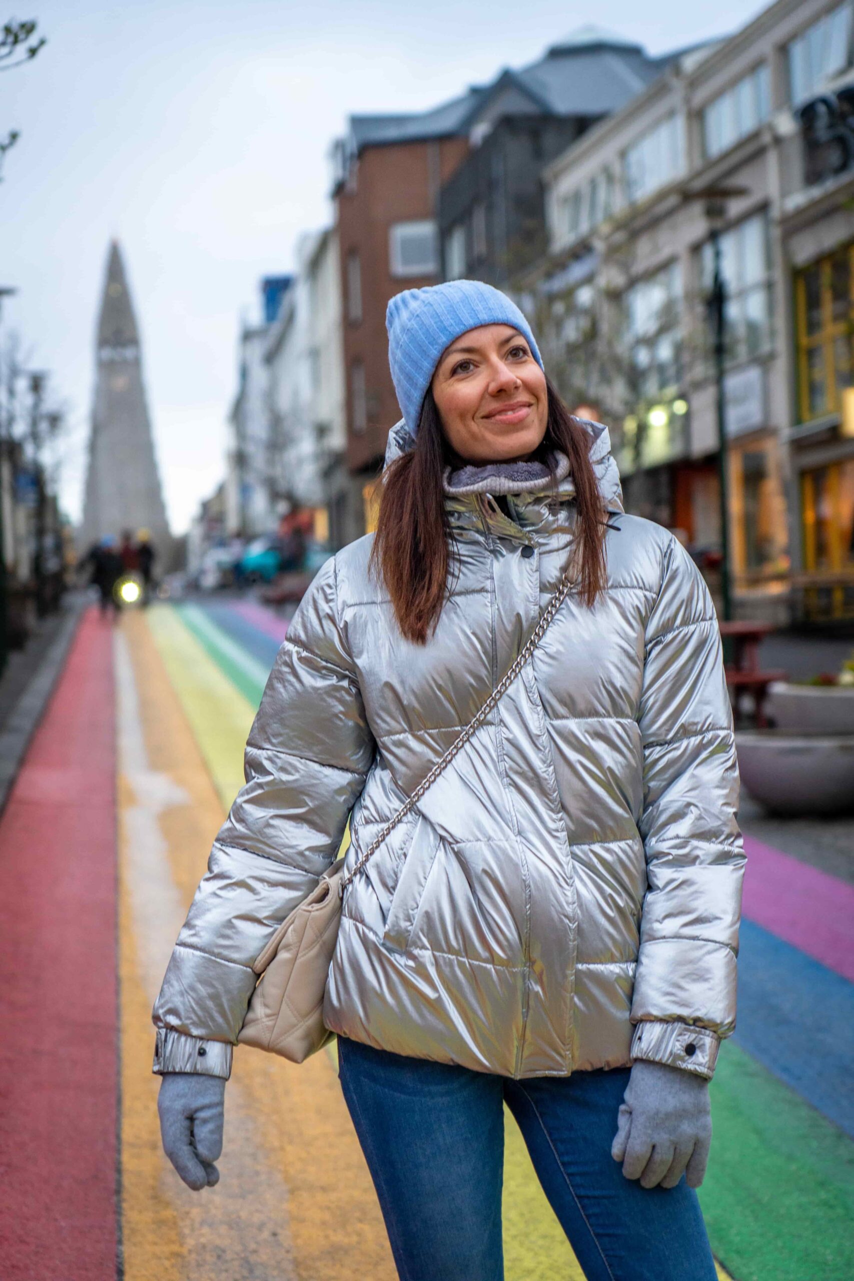 A woman walking down the Rainbow Street in Reykjavik