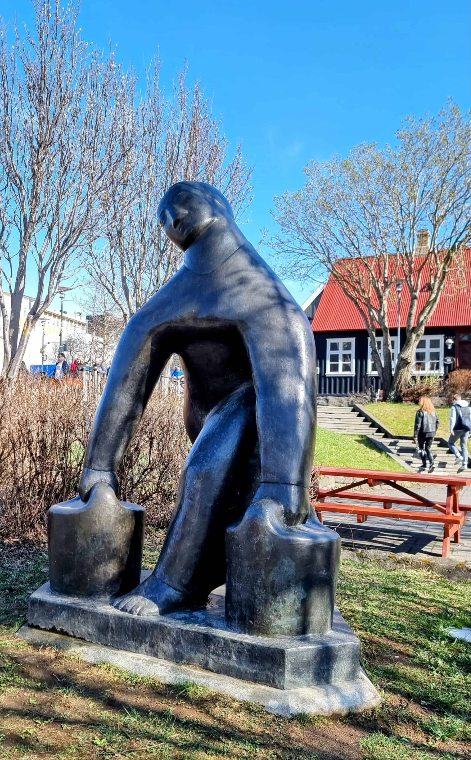 A picture of the Vatnsberinn Statue in Reykjavik - showing a woman carrying 2 water buckets