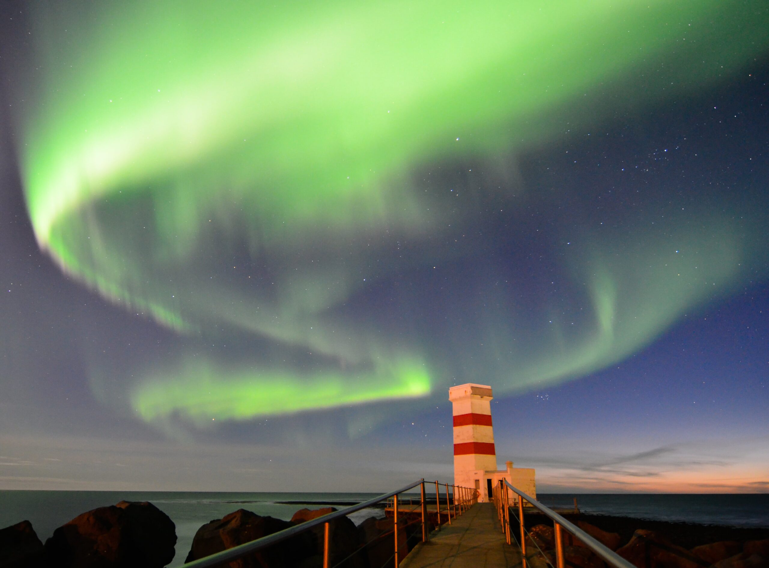 The northern lights over the Lighthouse in Gardur, located in southwest Iceland