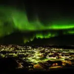 Northern lights over a town at night