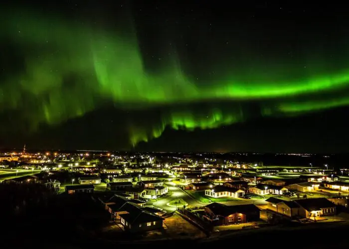 Northern lights over a town at night