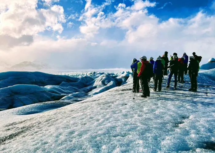 A group of people standing on a glacier