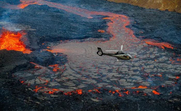 A helicopter above a volcano