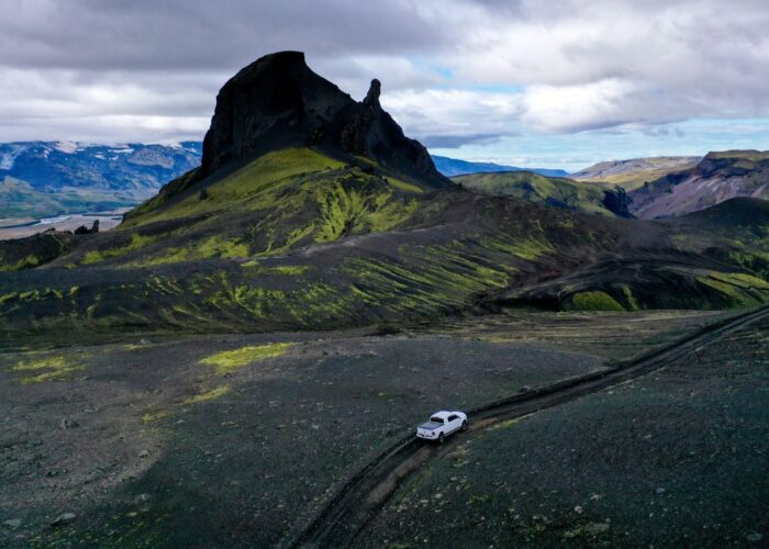 A white jeep driving through a black landscape