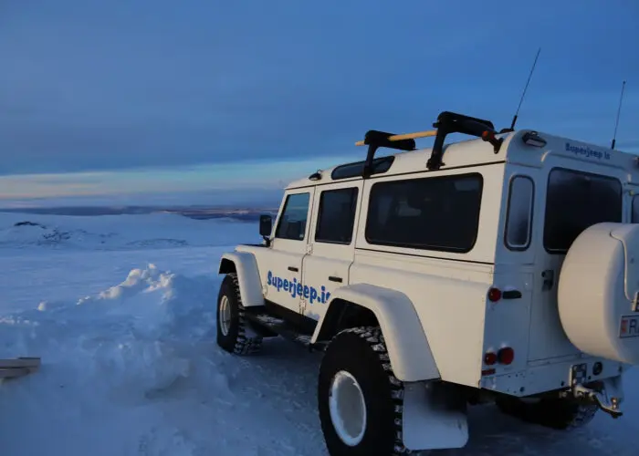 A white superjeep in a snowy environment