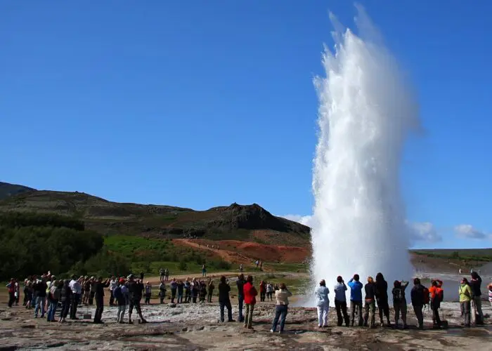 A surge of water from a hot spring geyser