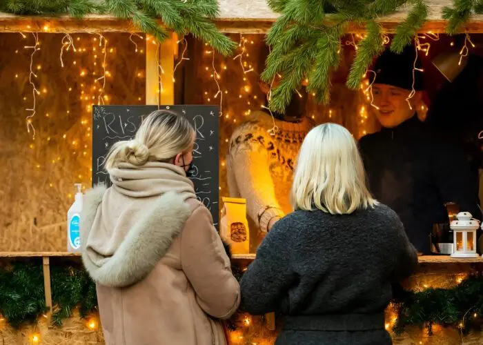 Two people being served at a Christmas shop