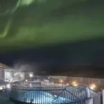 Hot springs below the northern lights as seen on the Golden Circle & Fontana Spa Experience