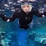 A diver in crystal clear waters at Silfra on the Private Golden Circle Snorkeling Tour