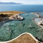 Aerial shot of the Geosea baths with people in the pools as seen on the Private Nature Lovers Tour from Akureyri