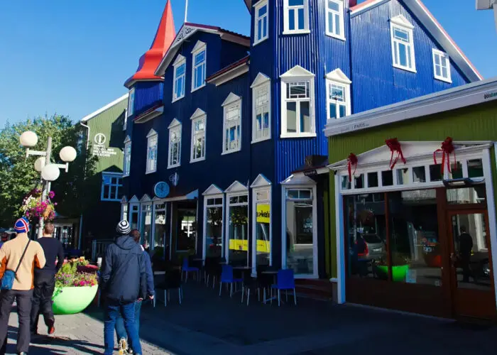 A picture of some blue houses with red roofs in Akureyri