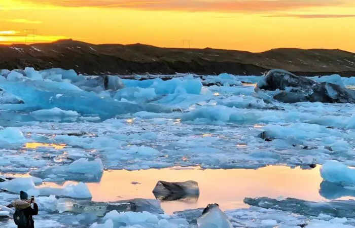 A lagoon with floats of ice in it at sunset