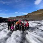 A group of women in hiking gear in the glaciers.