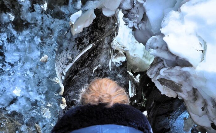 Woman and ice roof above her head.