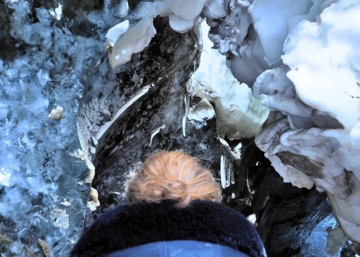 Woman and ice roof above her head.