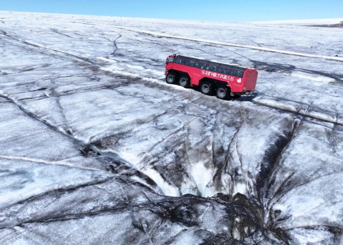 Red custom monster truck exploring the glaciers.